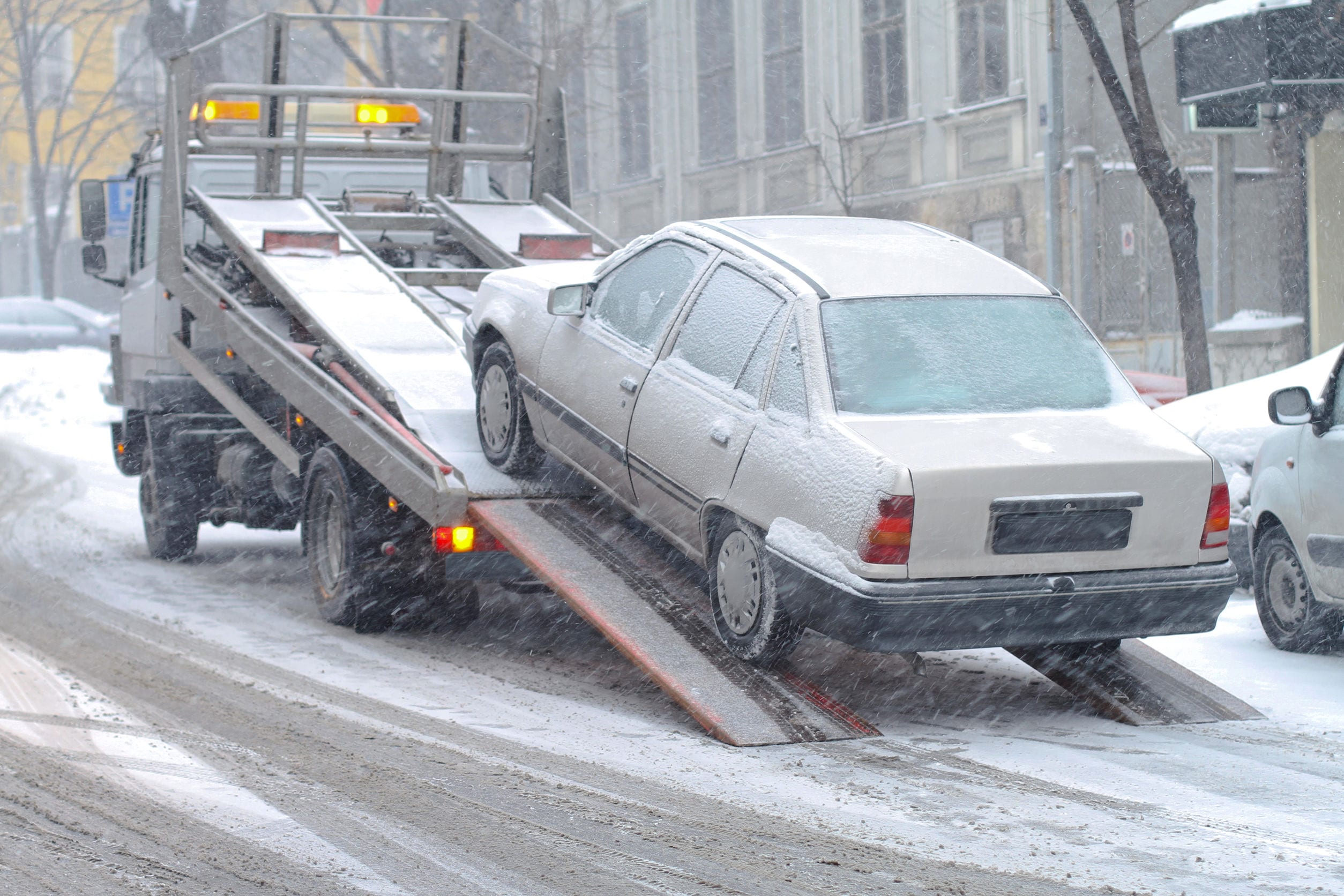 Car breakdown and towing assistance at snowy day